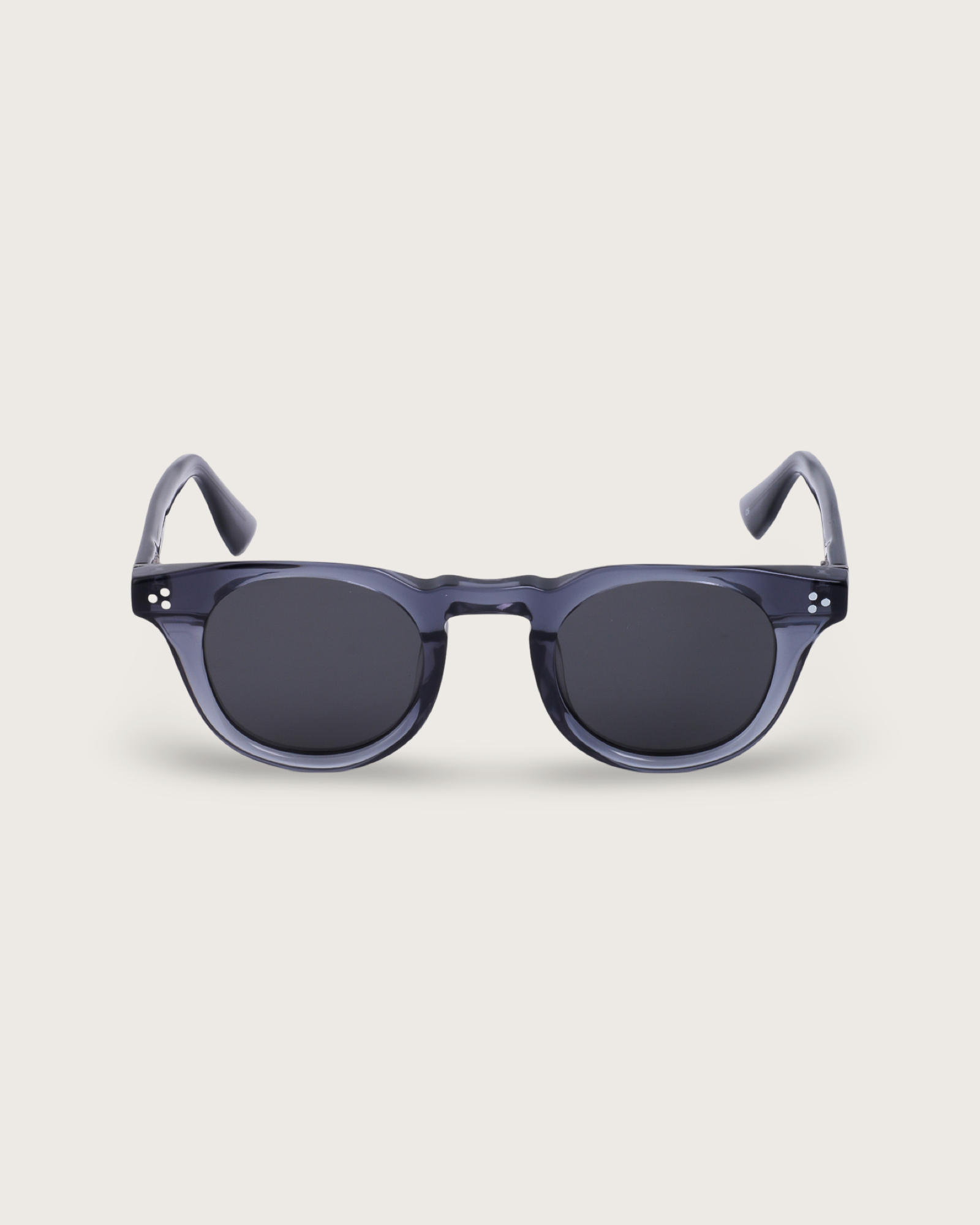 Aero Blue Noir sunglasses with a translucent navy acetate frame and sleek black lenses, featuring a rounded silhouette.