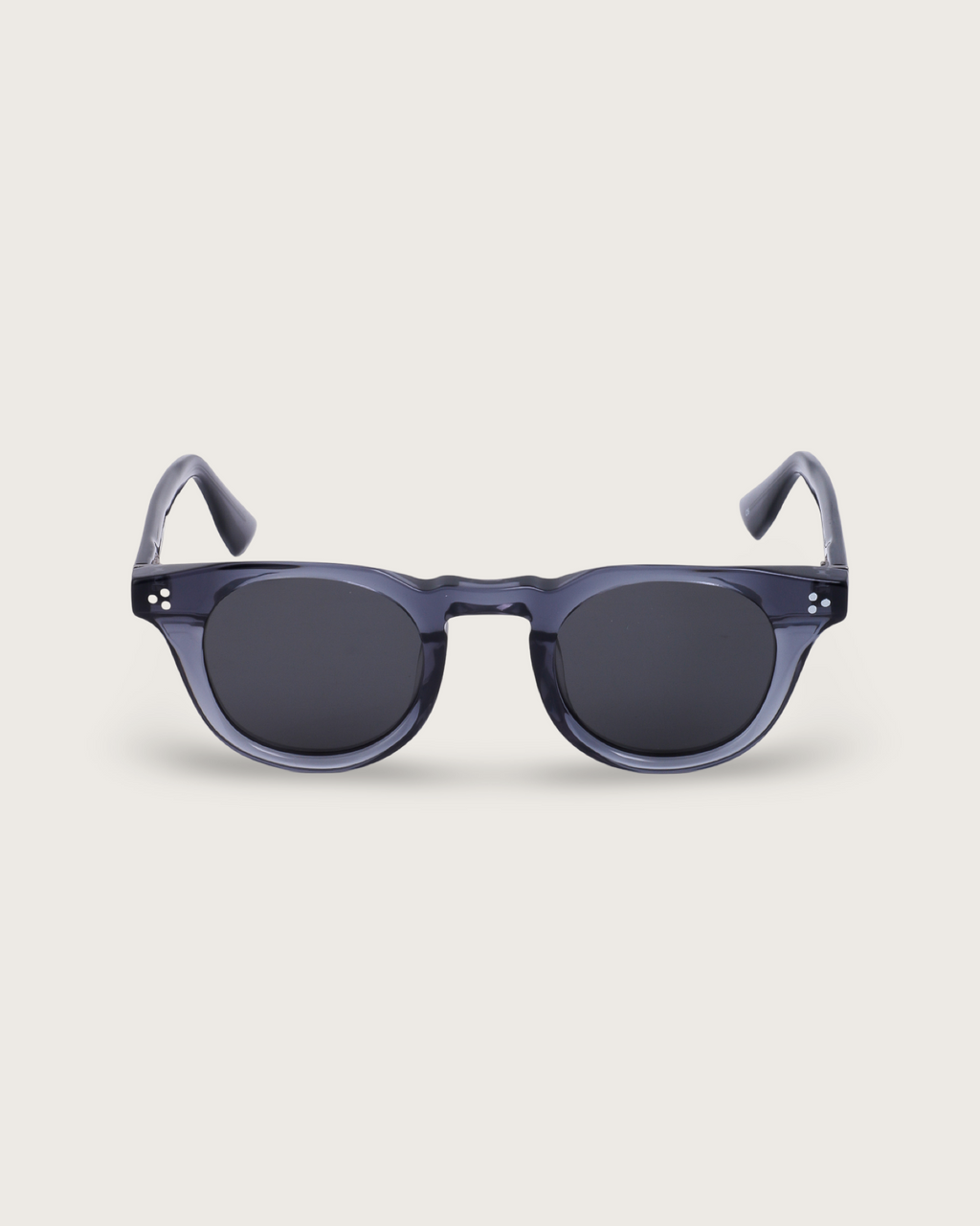 Aero Blue Noir sunglasses with a translucent navy acetate frame and sleek black lenses, featuring a rounded silhouette.