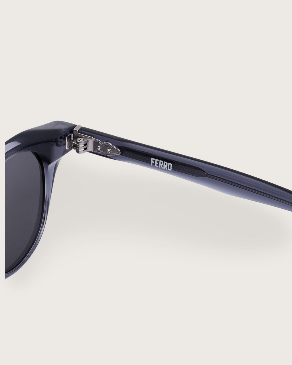 Detail shot of Aero Blue Noir sunglasses, showcasing the navy acetate frame and FERRO engraved temple.