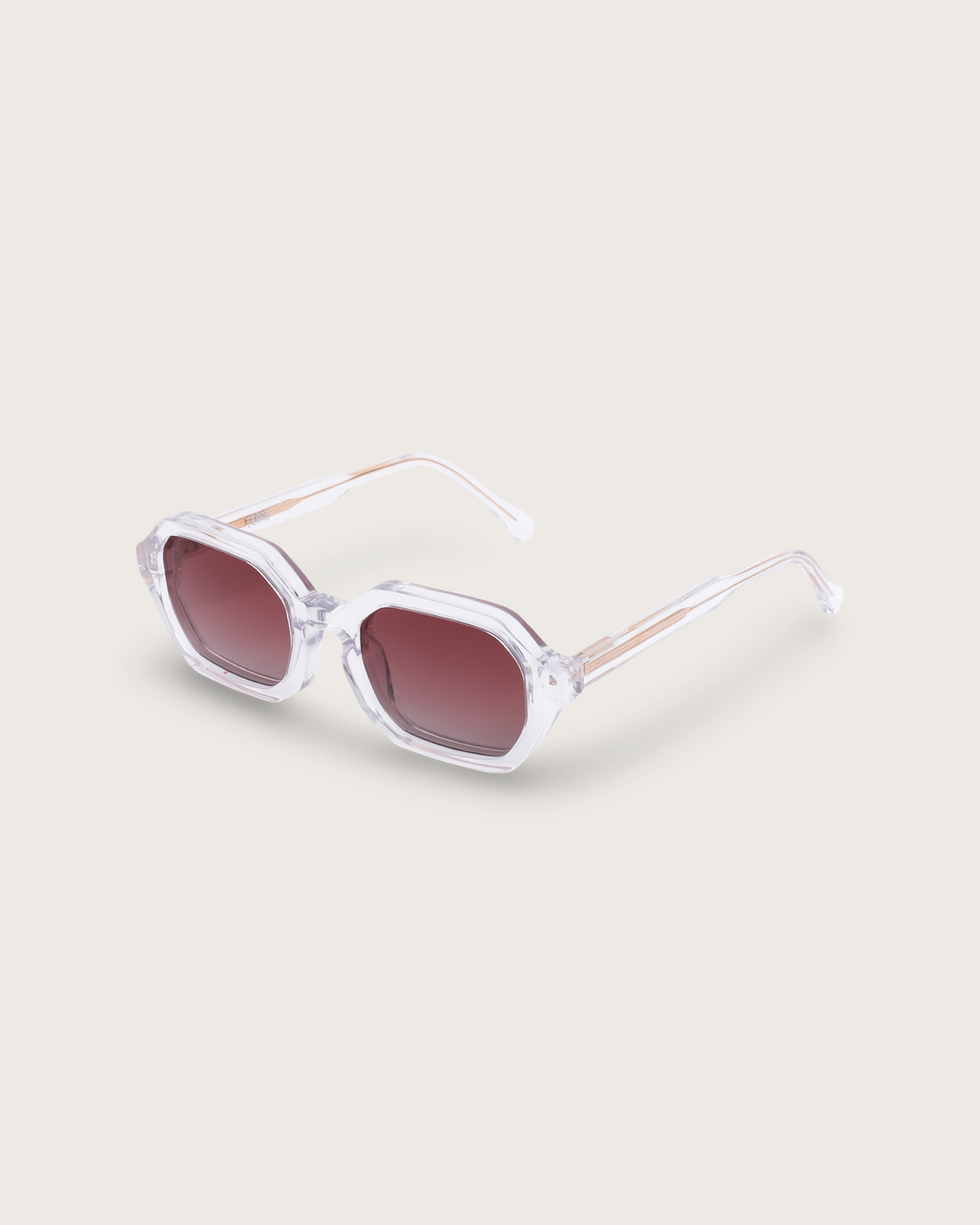 FERRO Crystal Ember sunglasses with transparent acetate frame and brown gradient lenses, blending minimalism and style.