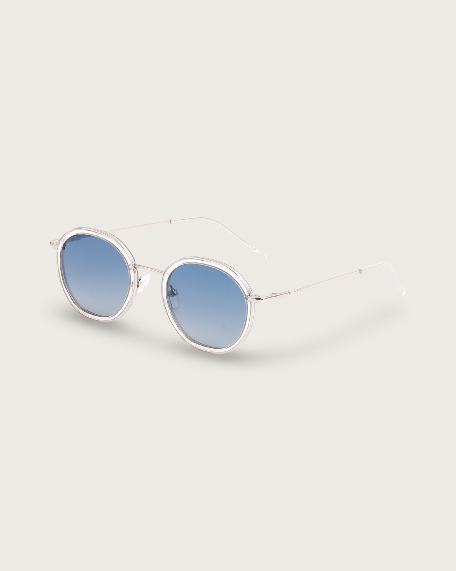 Dune Silver sunglasses with lightweight silver metal frames and polarised blue gradient lenses, showcasing a modern rounded silhouette.