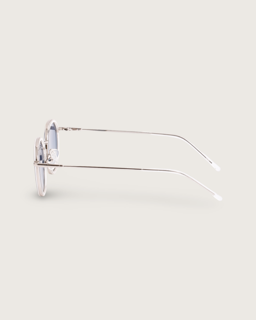 Side view of Dune Silver sunglasses with lightweight silver metal frames and sleek rounded silhouette.