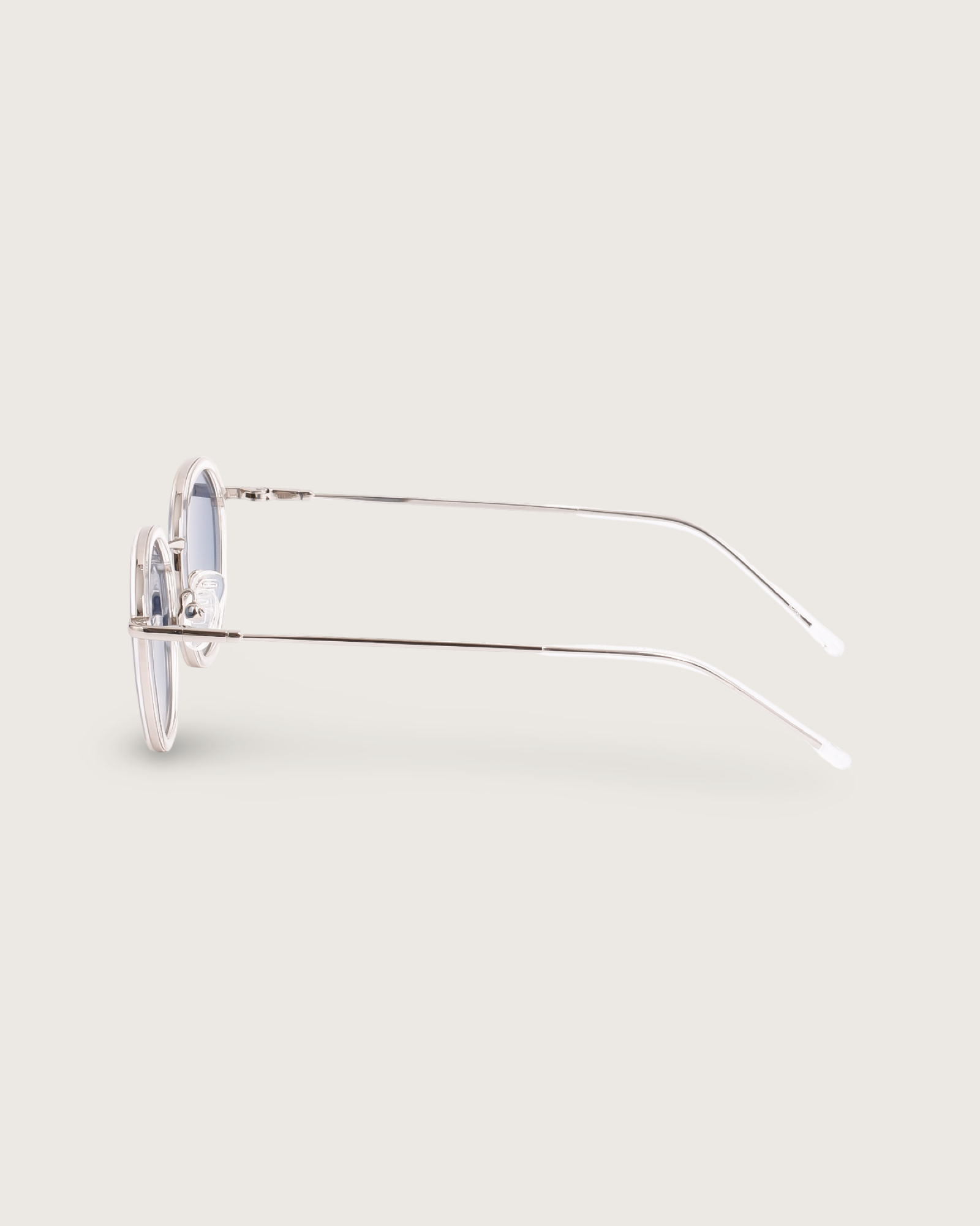 Side view of Dune Silver sunglasses with lightweight silver metal frames and sleek rounded silhouette.